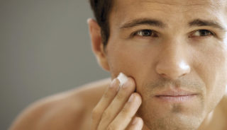 2018 Close-up of young man applying shaving cream